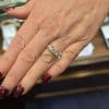 Diamond engagement ring on woman's finger.