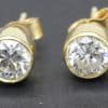 Gold and diamond stud earrings with sparkling gemstones for women.