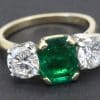 Elegant emerald and diamond ring with gold band.