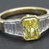 Yellow diamond ring with baguette diamonds, perfect for engagement or special occasions.