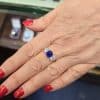 Elegant sapphire and diamond ring on a woman's finger.
