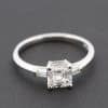 Silver engagement ring featuring a stunning square-cut diamond centerpiece.