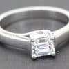 Elegant silver engagement ring featuring a stunning emerald cut diamond centerpiece. Perfect for spe.