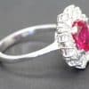 Elegant ruby and diamond ring with a silver band, perfect for special occasions.