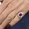 Elegant ruby and diamond ring on a woman's finger.