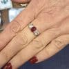 Ruby and diamond ring on a woman's finger.