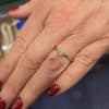 Close-up of a diamond engagement ring on a woman's finger.