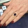 Sapphire ring with diamond accents on a woman's hand at Weldons Jewellers.