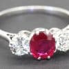 Stunning ruby and diamond ring with a central red gemstone and sparkling side stones.