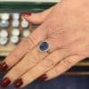 Sapphire and diamond gold ring showcased on a woman's hand.