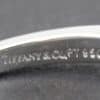 Close-up of Tiffany & Co. ring with engraved logo.