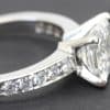 Silver engagement ring with sparkling diamonds on band and center stone.