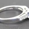 Sapphire and diamond engagement ring with a silver band, perfect for special occasions.