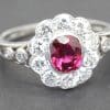 Silver ring with central ruby surrounded by diamonds, jewelry for special occasions.