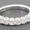 Diamond eternity ring with sparkling round-cut stones in platinum setting.