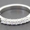 Diamond eternity ring with sparkling stones on a silver band.