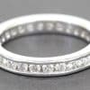 Diamond eternity ring with sparkling stones in a silver band.