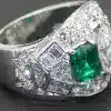 Elegant emerald and diamond ring with intricate design, crafted by Weldons Jewellers. Perfect for sp.