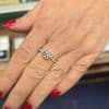 Elegant diamond engagement ring on a woman's hand.