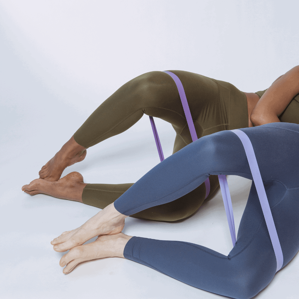 Couple performs banded hip rotation exercises during a injury prevention workout program - Body360 Fit Los Angeles