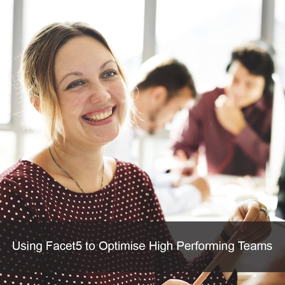 Employee in office environment smiling with other members of the team