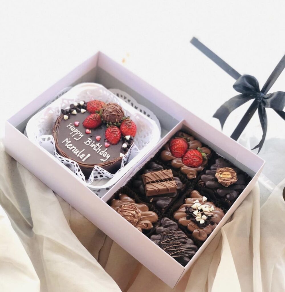 Beautiful gift box with chocolate bento cake and decorated chocolate brownies 