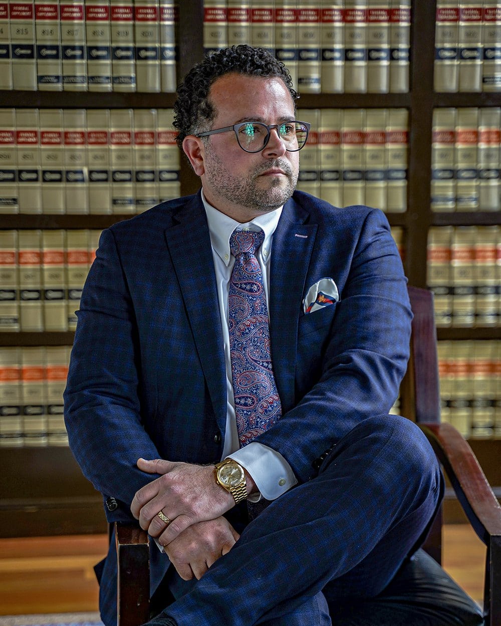 Attorney Michael F. Campopiano seated in the law library at his Providence office
