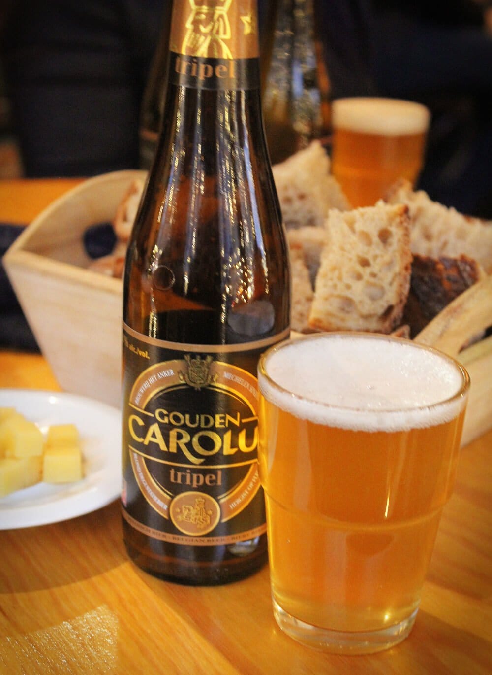 Drinking a tasty Belgian beer with cheese and bread. Not in a Belgian bar, mind you, this is actually in a Belgian beer store. Awesome, right?