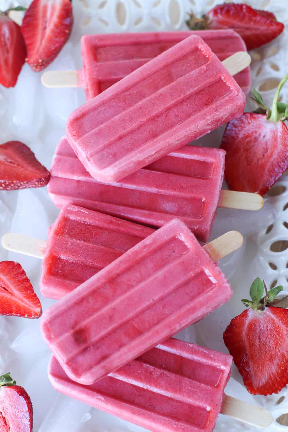 Keep cool this summer with these healthy Strawberries and Cream Popsicles.  This healthy summer popsicle recipe is easy and delicious. This strawberry popsicle recipe can be made with fresh or frozen strawberries. Cool off with this easy popsicle recipe.