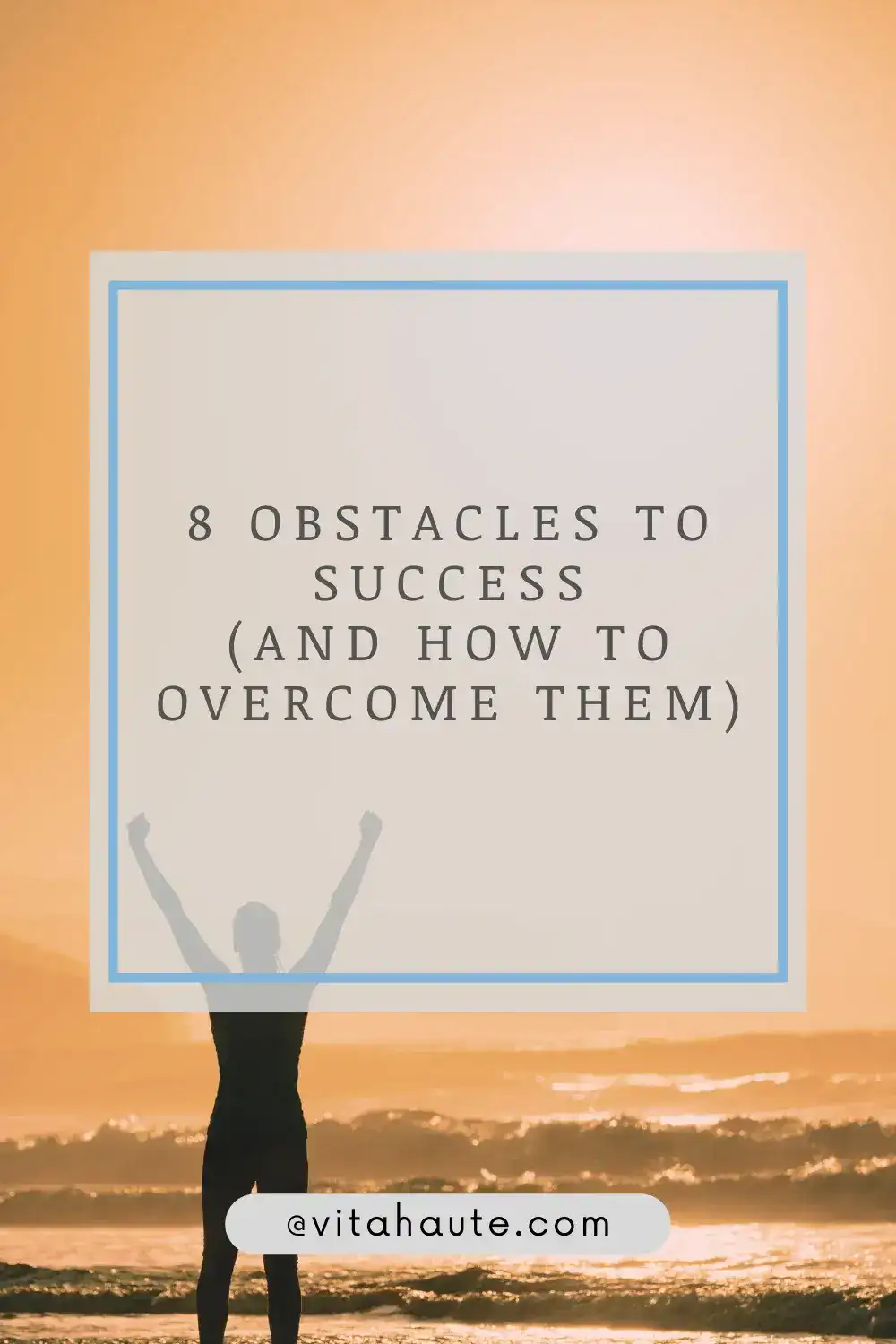 A man on top of a mountain lifting his arm in triumph