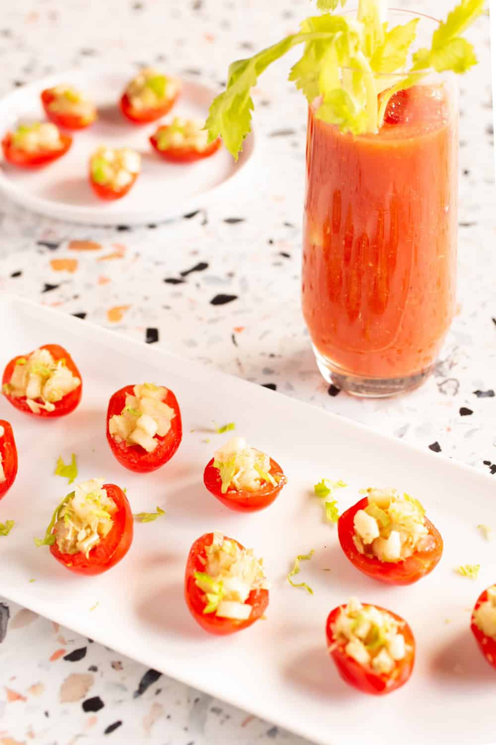 appetizer plates of Bloody Mary tomatoes stuffed with celery