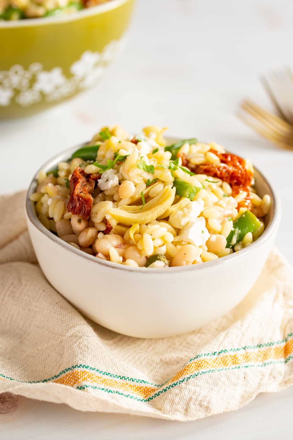 bowls of mediterranean orzo salad with green beans and sun-dried tomatoes