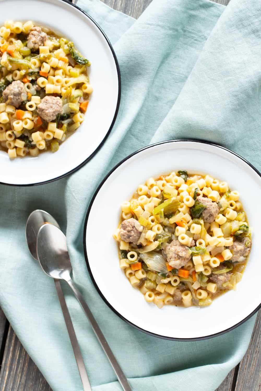 bowls of Italian wedding soup with tiny meatballs and tube pasta