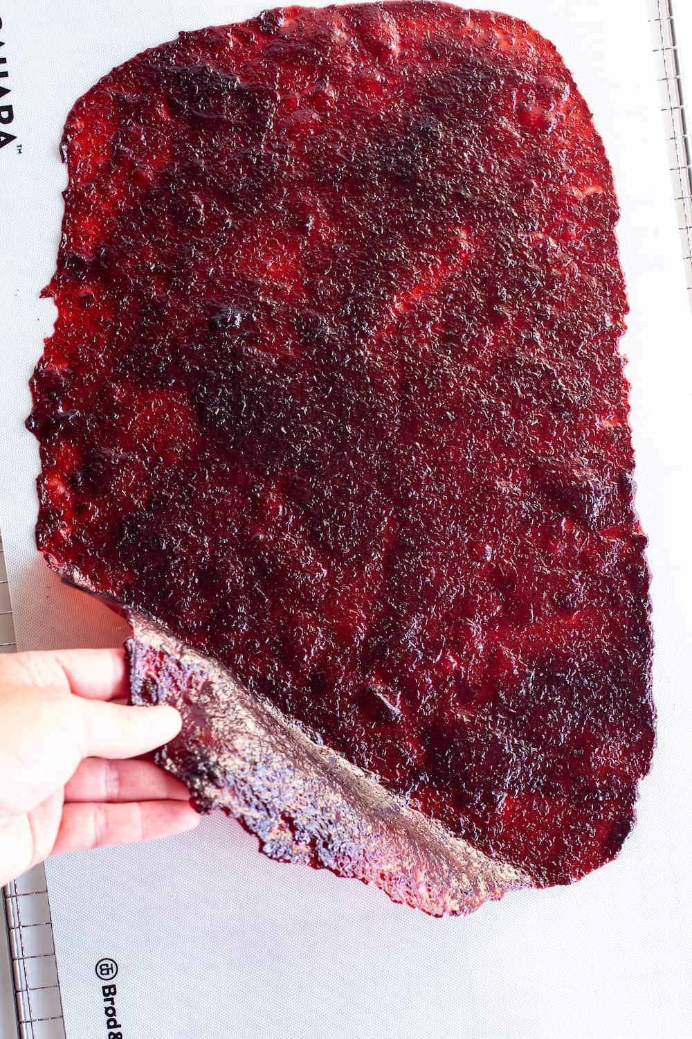 lifting a grape fruit roll-up off a silicone mat