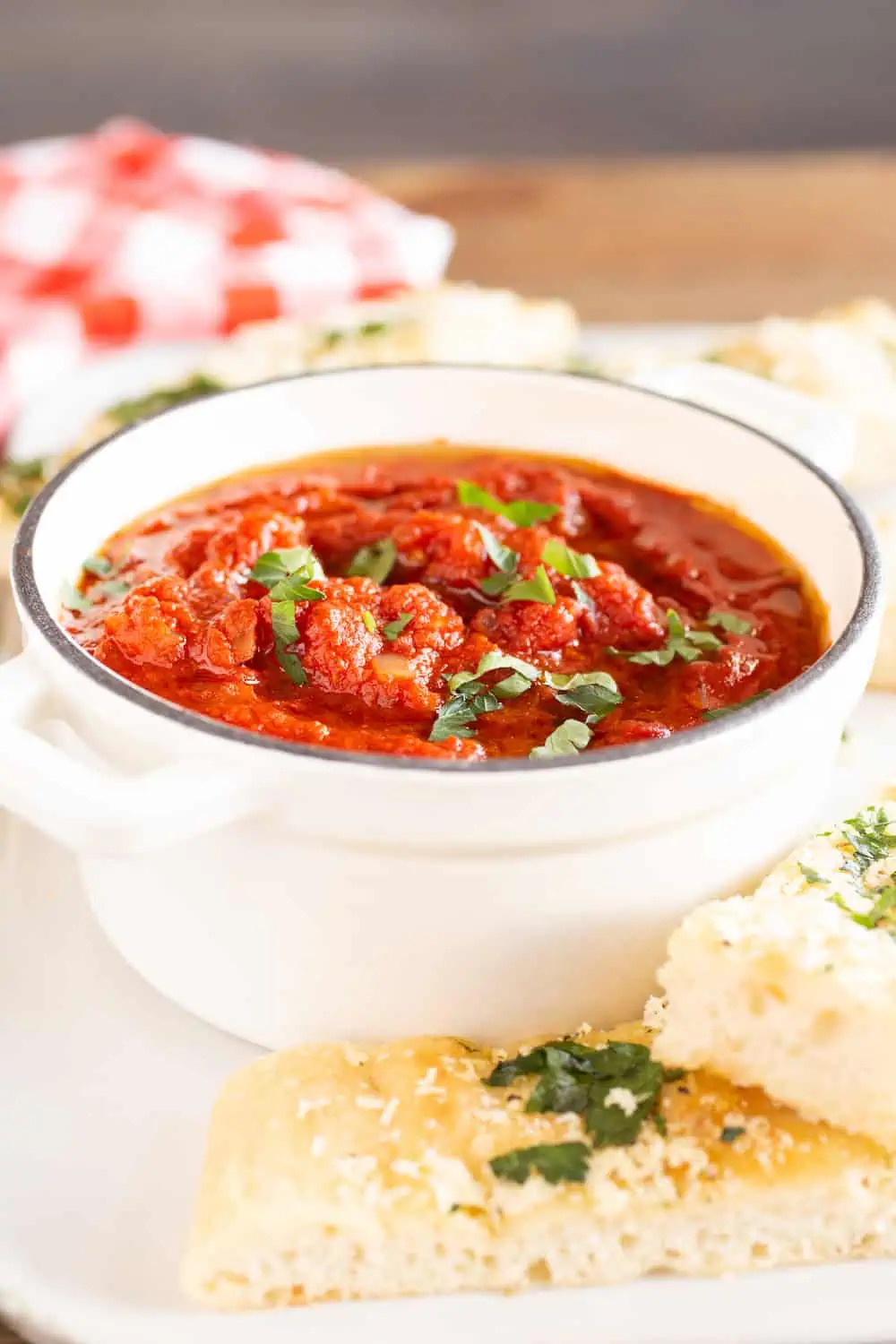 crock of marinara sauce with breadsticks