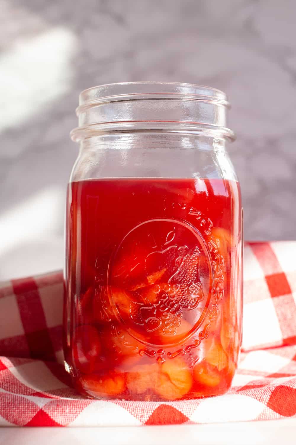 mason jar filled with sour cherry shrub