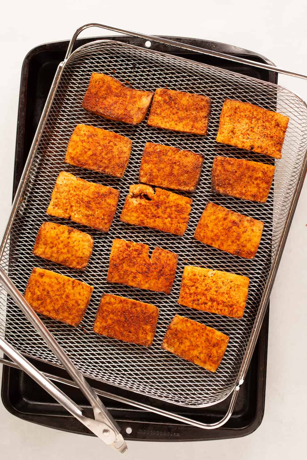 air fryer rack of cooked vegan tofu pastrami
