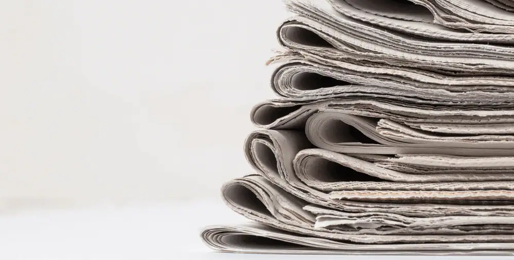 Stacked and folded newspapers