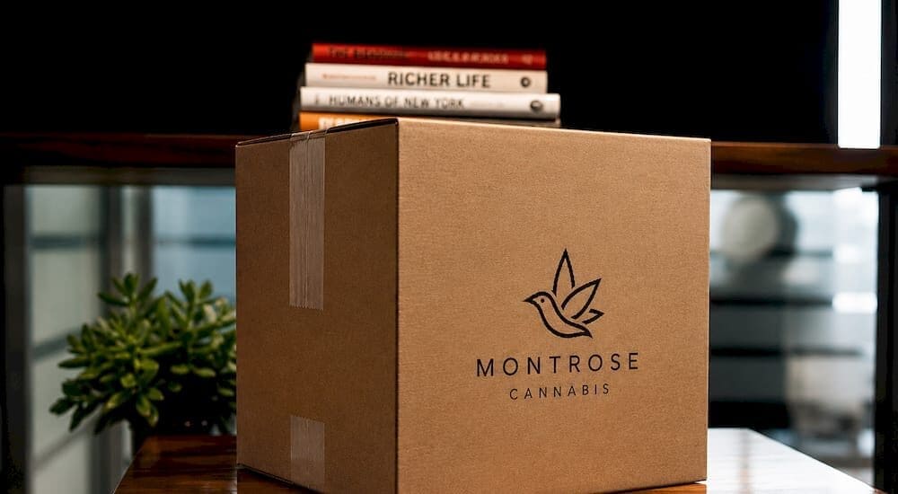 Person unboxing cannabis subscription package - Cannabis Subscription Box