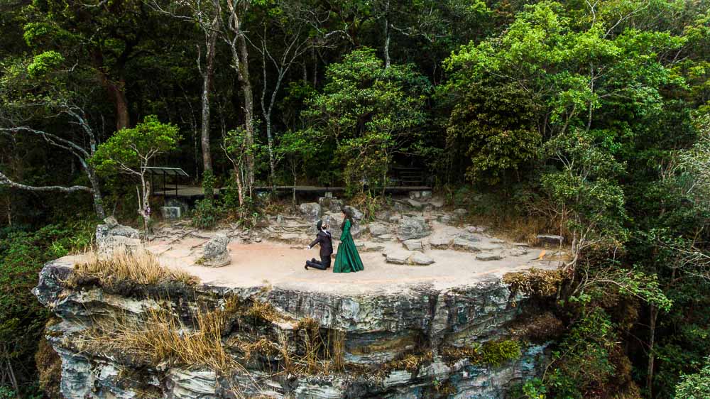 Couple photographed against forest and rock formations in Khao Yai