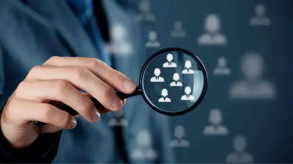 An engaged audience in a cozy coffee shop, eagerly listening to a speaker discuss target audience strategies