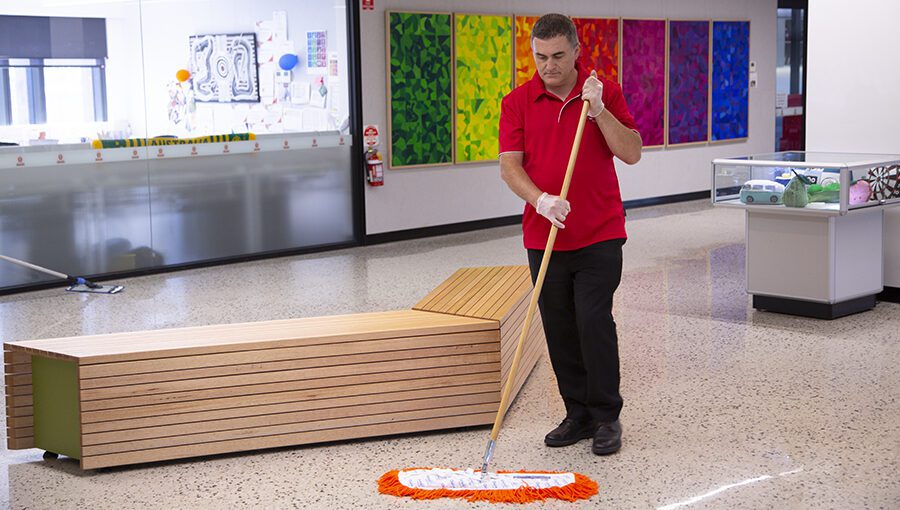 AMC Commercial cleaner mopping the floors of common areas in school facility
