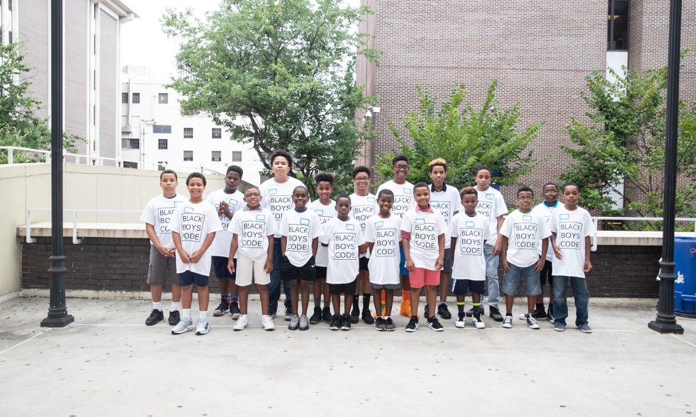 Group image of students wearing Black Boys Code t-shirts at a Black Boys Code workshop