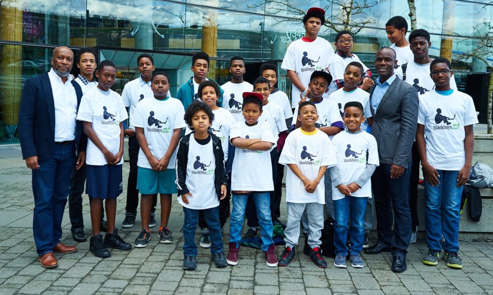 Bryan Johnson, left, a coding workshop crew and Germain Tanoh, who talked to the boys about his path to becoming a mathematician.
