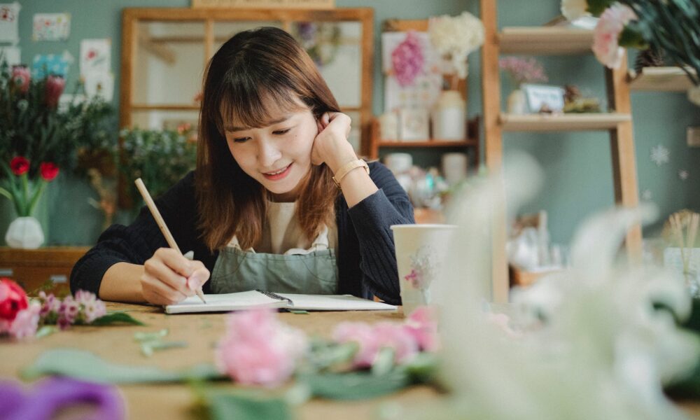 cheerful asian woman working in floral shop