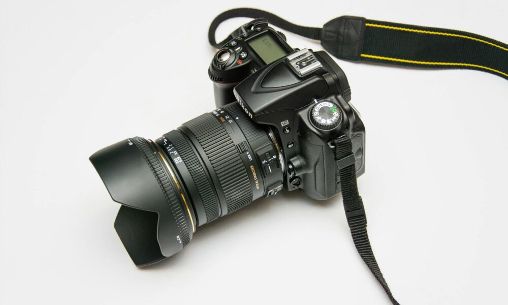black dslr camera on white surface