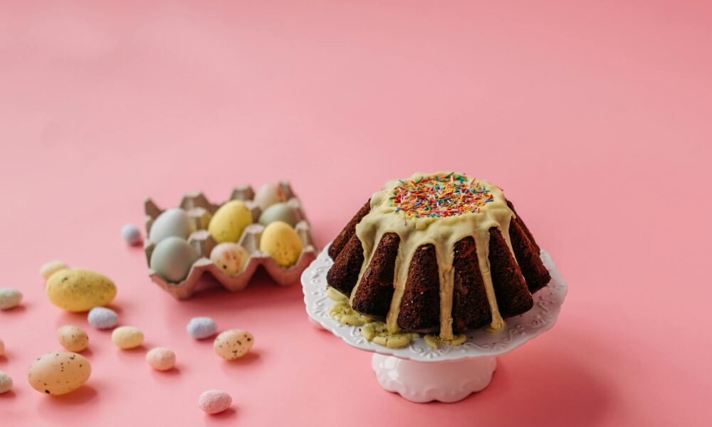 easter eggs and cake on pink background