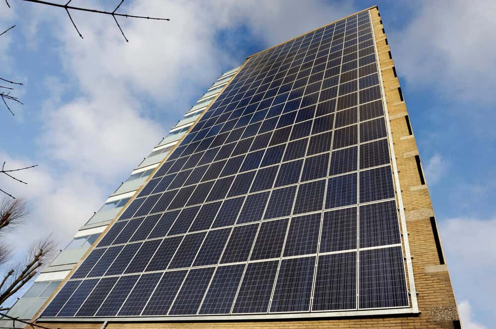 modern block of flats with solar panels on the side