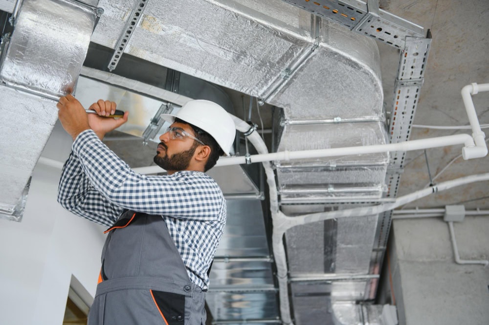 technician-using-highpowered-vacuum-clean-air-ducts_