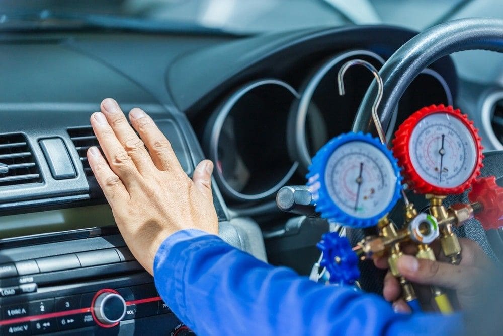 car mechanic checking car aircon